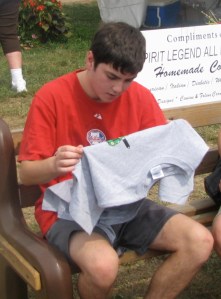 Clay holding t shirt