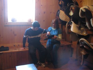 Room with saddles hanging on wall